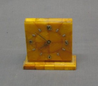 An Art Deco bedroom time piece contained in a tile finished case with Arabic numerals