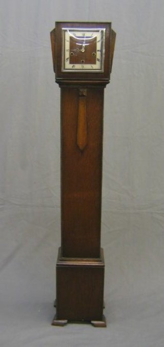 An Art Deco 8 day chiming "Granddaughter" clock with square dial and Roman numerals contained in an oak case 57"