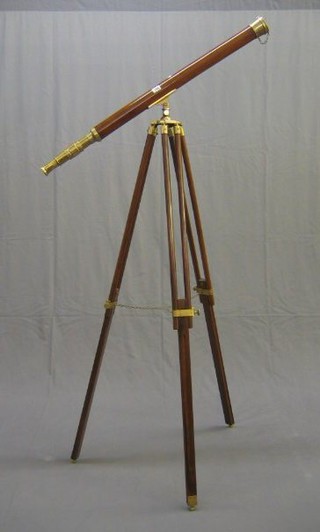 A reproduction 19th Century mahogany and brass 2 draw telescope complete with tripod