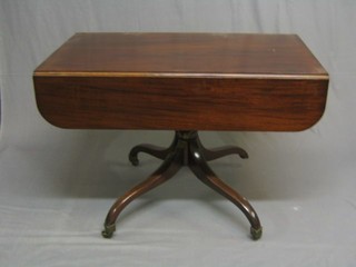 A 19th Century pedestal Pembroke table, raised on tripod supports ending in brass caps and castors 42"