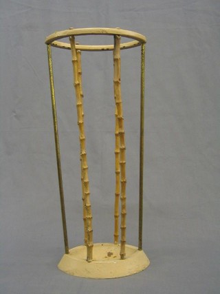 An oval bamboo and iron umbrella stand 9" together with a pierced mesh spark guard