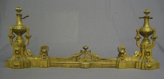 A 19th Century French gilt metal expanding fire curb with urn decoration 44"