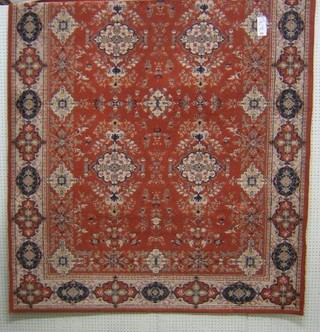 An orange ground machine made Persian style carpet 94" x  67"