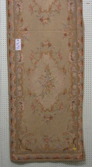 An Aubusson green ground and floral patterned runner 94" x 28"