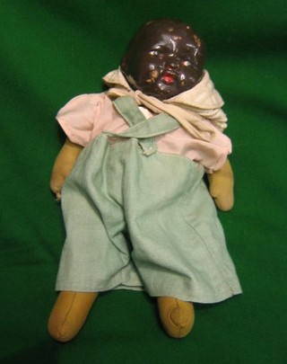 A 1930's black baby doll with composition head and fabric body