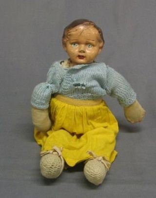 A 1930's composition headed doll with fabric body
