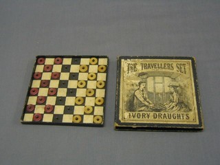 A Victorian travelling set of ivory draughts, boxed