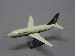 A plastic model of a British Caledonian Boeing 737 7"