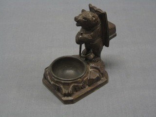 A steel ashtray contained in a carved Swiss bear 5"