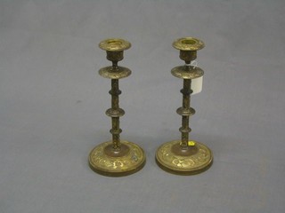 A pair of cast brass candlesticks 9"