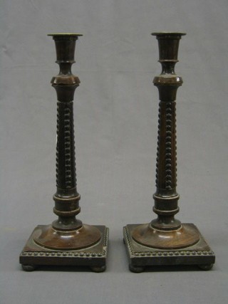 A pair of carved and turned oak candlesticks 13" and a pair of oak chamber sticks