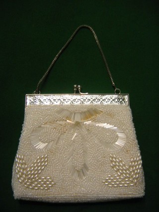 A lady's white bead work evening bag