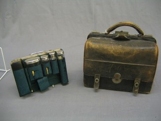 A lady's 19th/20th Century Gladstone travelling bag, the front section fitted 4 cut glass bottles with silver plated mounts, together with various manicure implements