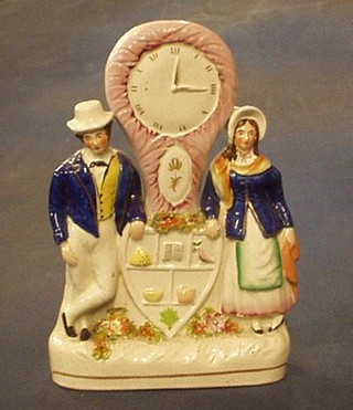 A 19th Century Staffordshire flat back figure group with clock supported by a lady and gentleman with Odd Fellows Arms, 10"