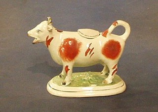 A 19th Century Staffordshire cow creamer in the form of a cow (horn f) 5"