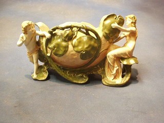 A 19th Century Austrian pierced boat shaped jardiniere supported by a figure of a girl and cherub (cherub finger missing and chip to the reverse base) 12"