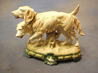 A 19th Century biscuit porcelain figure group  with 2 pointers raised on an oval base 7"