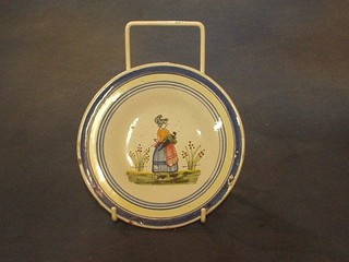 A circular Quimper plate decorated a lady, base marked JHF? 6"