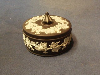 A circular Wedgwood black Jasperware jar and cover, base impressed Wedgwood 66, 5"