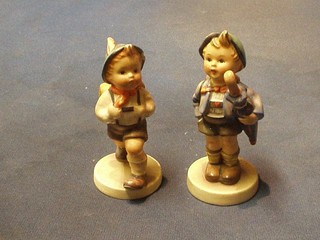A Hummel figure of a hiker (chip to hat) and 1 other boy with umbrella and pannier with pig (2)