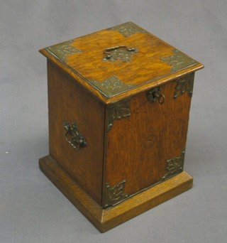 An oak cigar box with embossed metal mounts 6"