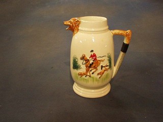 A 1930's pottery jug decorated a hunting scene, the spout in the form of a foxes mask and the handle in the form of a riding crop 8"