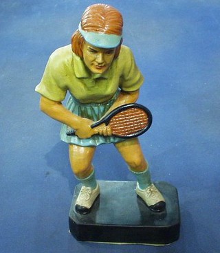 A terracotta figure of a lady tennis player 12"