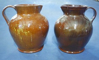 A similar pair of brown Dickerware jugs 10"
