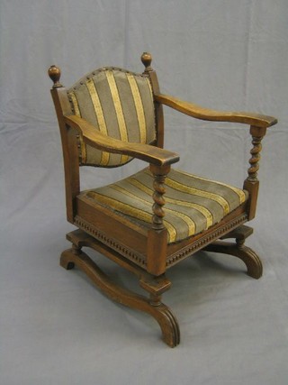 "The Hanfold Spring Chair" - an oak framed Tudor style open arm rocking chair with spiral turned decoration