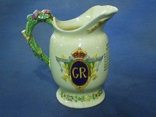 A Crown Devon George VI 1937 Coronation jug with musical box movement to the base (f and cracked)