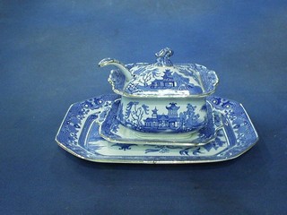 A 15 piece blue and white Willow pattern dinner service comprising 2 rectangular twin handled tureens and covers 10", a rectangular meat plate 11", a square sauce tureen stand and cover with ladle 7", a sauce boat, 6  side plates 8", 5 tea plates 7"