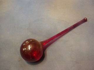 A large red glass hydrometer 16"