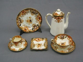 A 40 piece Derby style tea service comprising  2 circular bread plates 9", muffin dish and cover, moustache cup and saucer, 4 egg cups, rectangular butter dish, 6, 7" plates, 5 cups and 5 saucers (2 cups cracked), 6 coffee cups and 6 saucers (1 cup cracked) and 1 associated square plate