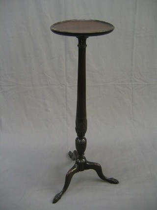 A 19th Century turned and reeded mahogany torchere raised on pillar and tripod supports