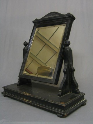 An Edwardian rectangular plate dressing table mirror contained in an ebonised swing frame 27"