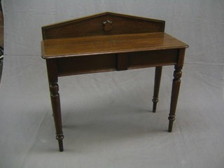 A Victorian oak hall table with raised back, fitted a drawer and on turned supports 41"