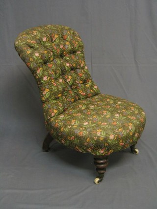 A Victorian mahogany framed nursing chair upholstered floral buttoned material, on turned supports  ceramic castors