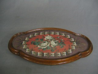 A Victorian mahogany shaped table top teapot stand with bead work panel to the centre, raised on 5 brass castors