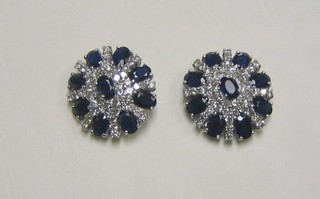 A particularly impressive pair of lady's white gold ear studs set 9 oval cut sapphires and numerous diamonds
