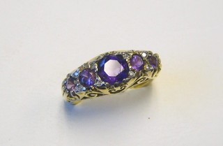 A lady's Victorian style 18ct gold dress ring set 5 graduated amethysts supported by diamonds
