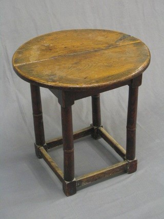 A 17th Century style circular oak occasional table, raised on turned and block supports 23" (crack to top)
