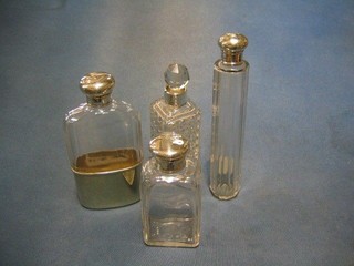 A cut glass flask with silver plated mounts, a glass dressing table jar with silver mount, a hobnail glass dressing table jar with silver mount and a pin jar