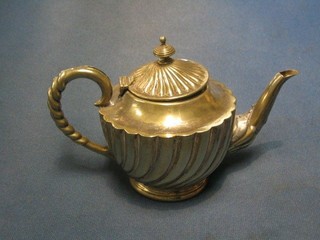 A circular silver plated teapot with reeded decoration