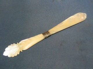 A Victorian carved mother of pearl newspaper opener with silver band, 9"