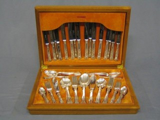 A modern part canteen of Queens pattern flatware contained in a teak canteen box