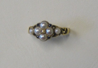 A lady's gold dress ring set 4 sapphires and a diamond and supported by 5 demi-pearls