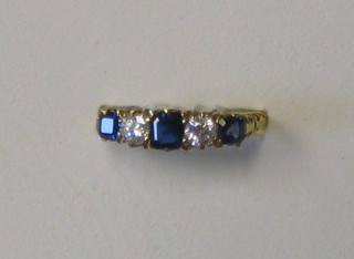 A lady's 18ct gold dress ring set 3 square cut sapphires supported by diamonds