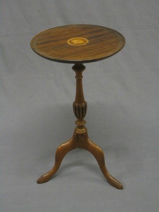 A Georgian style circular inlaid mahogany wine table raised on pillar and tripod supports 12"