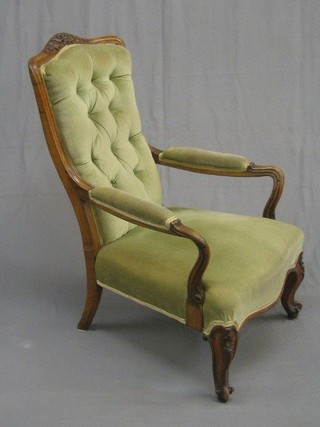 A Victorian carved walnut show frame open arm chair, upholstered green buttoned Dralon, on French cabriole supports