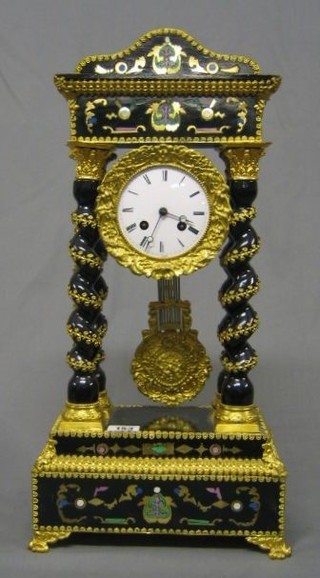 A 19th Century French 8 day striking Portico clock with enamel dial and Roman numerals (slight chip to dial) contained in an elaborate gilt metal and inlaid case, supported by 4 spiral turned columns